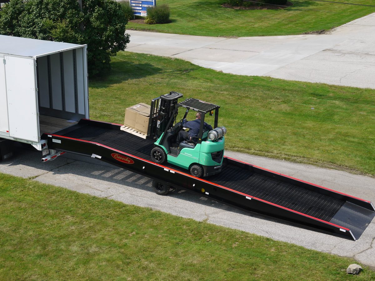 A forklift traveling up one of Copperloy's loading ramps.